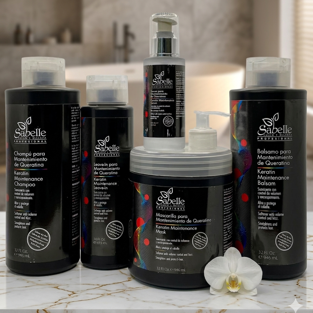 Collection of Sabelle hair care products on a marble surface with an orchid flower.
